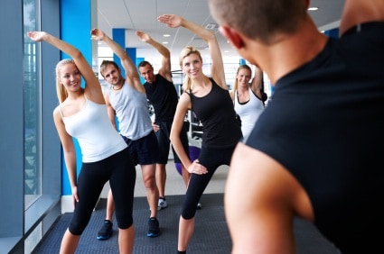 Fitness Instructor Leading Stretches